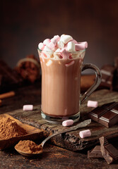 Hot chocolate drink with marshmallows on a brown background.