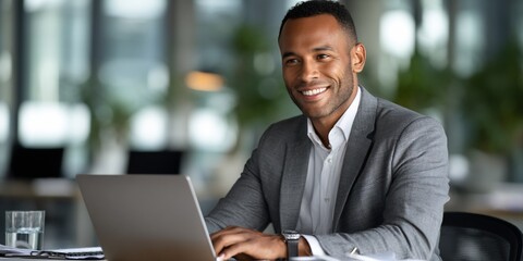Businessman working on laptop in office.  Possible use  Business, professional, career, corporate