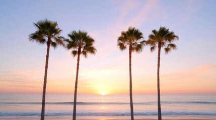 Obraz premium Sunset over ocean with palm trees silhouetted against colorful sky