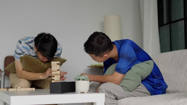 Brother and younger brother play board games together.