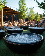 group of people relaxing in black rounded tubs with ice at an outdoor in the park. recovery, resilience, and mindfulness.wellness and detox in nature.
