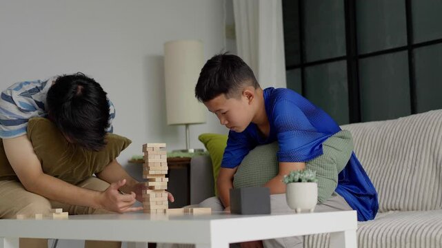 Brother and younger brother play board games together.