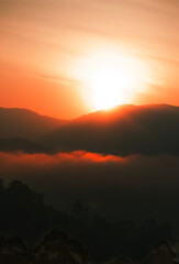 Fototapeta premium Sunrise over misty mountain range