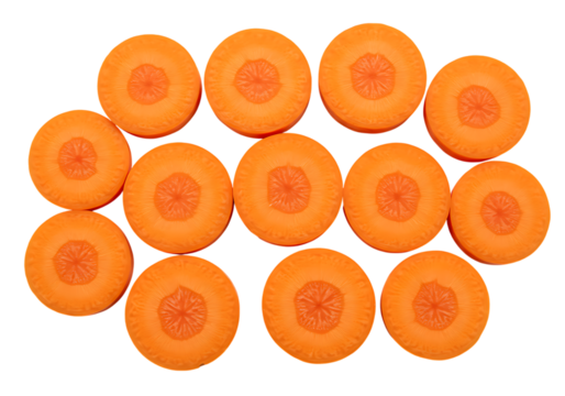 A top down view of many orange carrot slices arranged on a black background in a pattern design on transparent background