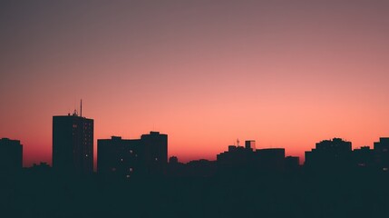 Fototapeta premium City skyline silhouette against a warm dusk sky, urban simplicity meets serene twilight.
