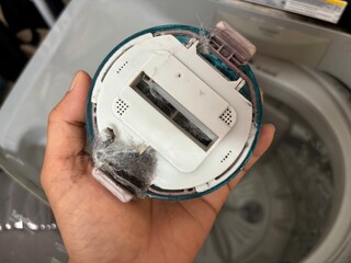 The debris filter cartridge of the washing machine is dirty and full of dog hair.