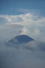 Erupting volcano mountain range aerial view cloudy skies nature's power majestic landscape
