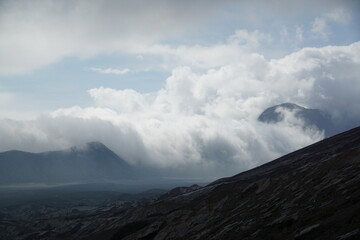 Nature's majesty clouds rolling over mountains remote landscape scenic viewpoint atmospheric wonder
