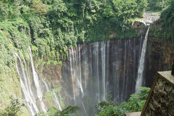 Majestic waterfall adventure in nature's oasis indonesia landscape photography lush green environment aerial view serenity