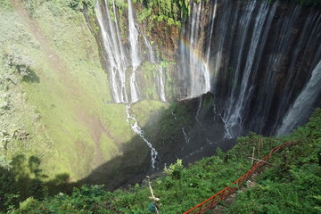 Majestic waterfall flowing into lush green valley indonesia nature photography scenic viewpoint natural beauty