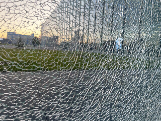 Broken glass on the background of a city street at sunset.