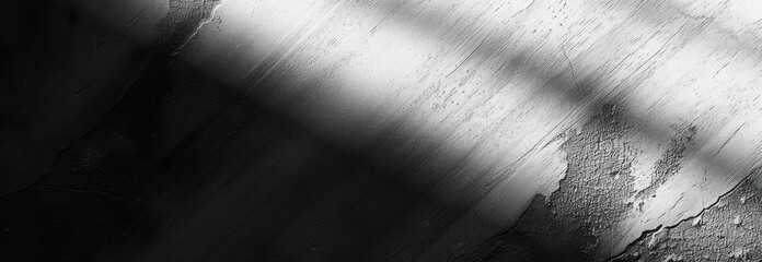 Obraz premium dark textured surface with rough patches illuminated by diagonal light beams creating a dramatic and mysterious atmosphere