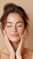 Fototapeta premium Studio beauty portrait of a serene young woman with glowing skin and hands on her face, showcasing skincare, natural beauty and facial wellness