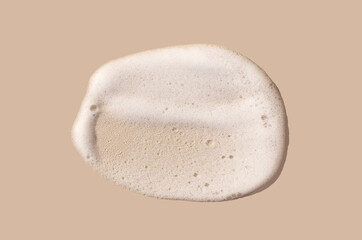 texture foam mousse foam cosmetic smear sample on beige background