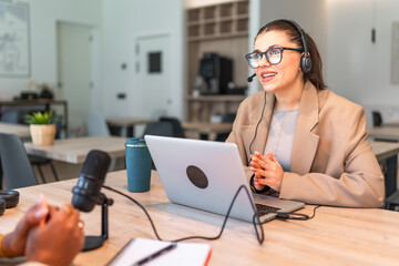 Podcasters recording a new episode in a modern studio