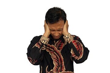 Asian man holding head facing camera showing stressed expression