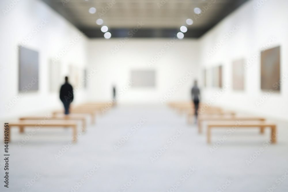 Poster blurred image of art gallery interior with visitors viewing paintings and sitting on benches.
