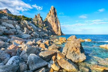 Remarkable view of Punta Pedra Longa and azure water in sea.
