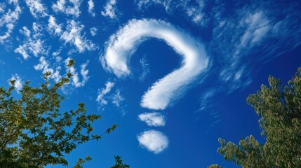 Clouds form a question mark in the blue sky over a green landscape during daytime