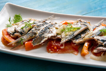 Piatto di sardine marinate con pomodoro e cipolla, antipasti mediterranei 