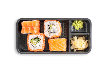 Top view of set of Philadelphia sushi rolls made with smoked or raw salmon, cream cheese, cucumber, avocado slices, seaweed and boiled rice isolated on white served with ginger and wasabi in container