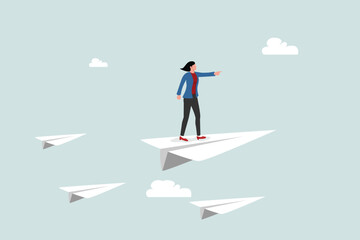 Business leadership, woman power to lead company to achieve target, smart confidence businesswoman standing on leading flying paper airplane origami pointing finger to the direction to reach goal