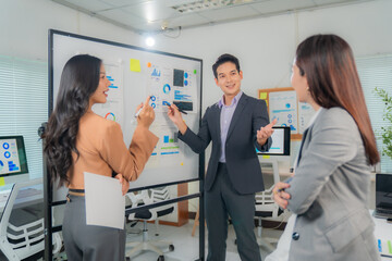 Business team analyzing financial charts and discussing company strategy during a meeting in a...