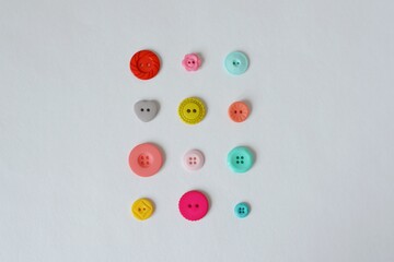 Colorful plastic buttons on white background
