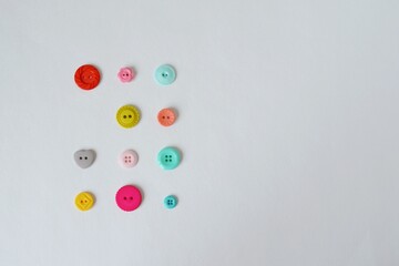 Colorful plastic buttons on white background	