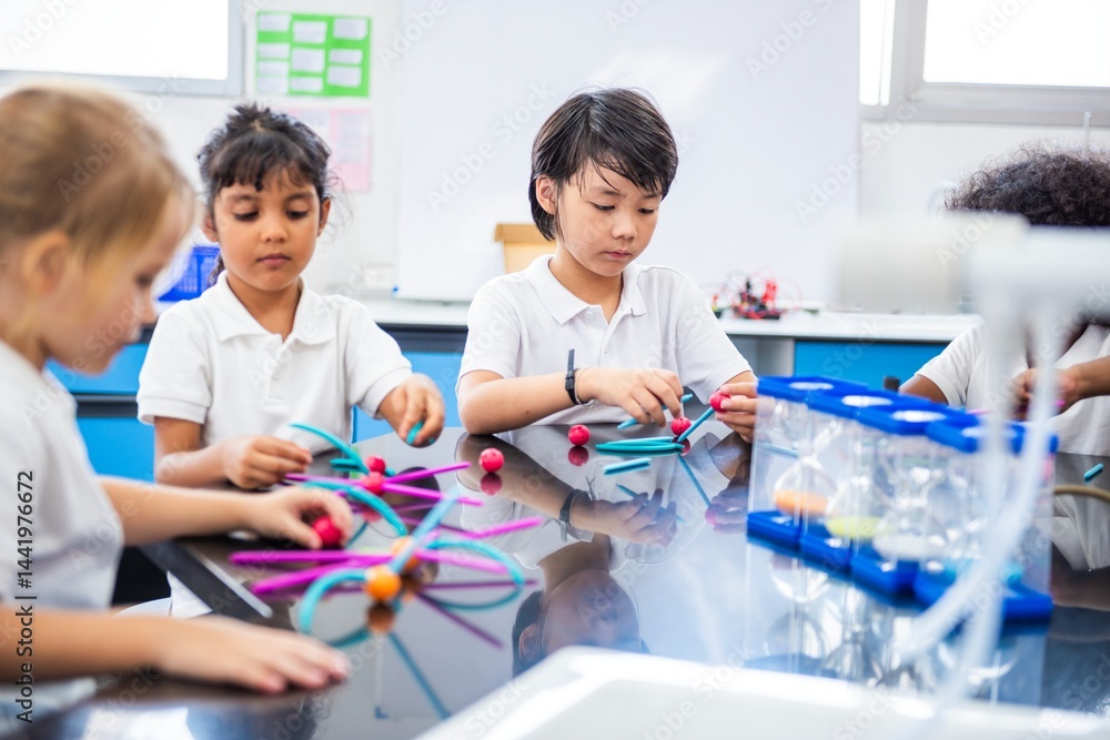 Poster Children in a classroom engaged in a science activity. Kids explore science with colorful materials. Classroom learning with young students and science tools. Children learning in science class.
