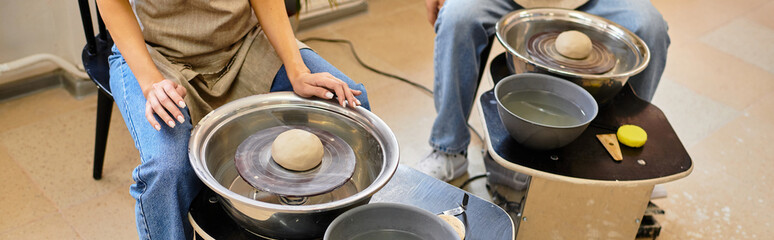 Young couple enjoys creative pottery making together in a cozy art studio