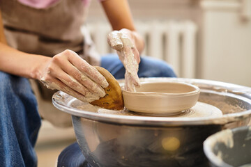 Crafting unique pottery creations in a vibrant and well lit studio environment