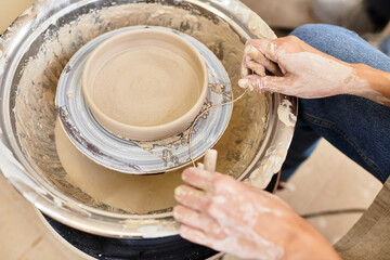Creating handmade pottery at a vibrant, well lit studio with passion and skillful hands