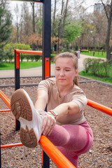 Woman stretching outdoors at fitness park