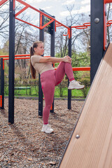 Woman stretching outdoors at fitness park