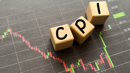 letters cpi with a blurred stock market candlestick chart in the background, symbolizing...