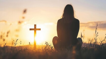 Woman praying beneath cross with sunset flare, hope and grace in nature