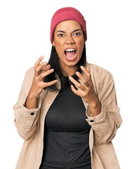 Young Filipino woman in studio screaming with rage.