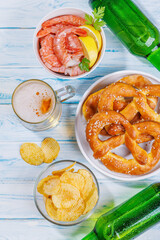 A vibrant photo showcasing a glass of beer surrounded by various snacks and fast food