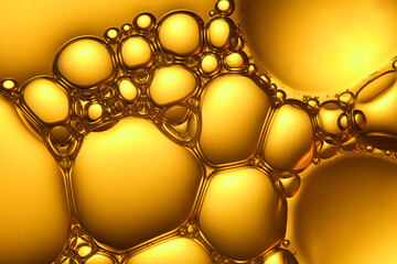 A cluster of bubbles, standing out against a shiny yellow collagen background. The bubbles are...