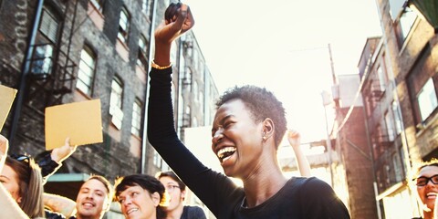African American black woman celebrate with diverse group of people in a protest. Black woman raise fist celebrate protest. Diverse group of people protesting and celebrating black lives matter
