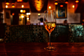 a glass of cold white wine and serving in the restaurant