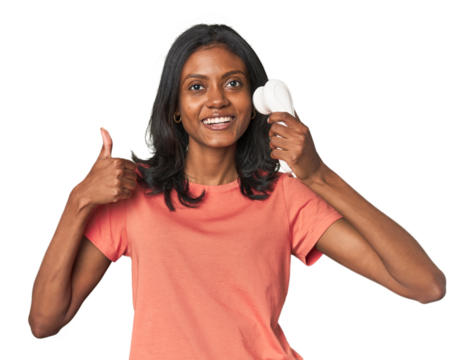 Young Indian woman with facial cleanser smiling and raising thumb up