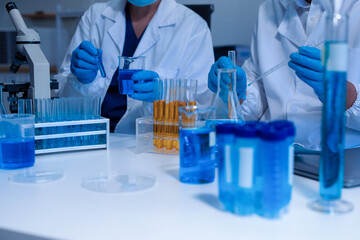 Lab work, Doctor holds a test tube takes the test from a test tube in analysis.