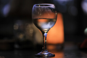 A glass of white wine on a blurred abstract background, alcohol, relaxation