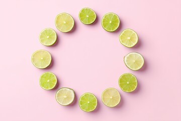Floating Lime Wedges Create a Circular Arrangement on a Pastel Pink Background for a Fresh and Vibrant Decoration