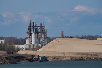 cement production plant, industrial plant, sand pits on the lake shore