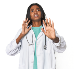 Young Indian doctor with stethoscope being shocked due to an imminent danger