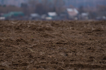 a plowed agricultural field , a spring landscape in the countryside