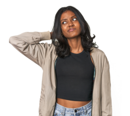 Portrait of a young Indian woman touching back of head, thinking and making a choice.